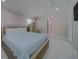 Bright bedroom with a queen-size bed and dresser at 659 Keene Rd, Largo, FL 33771