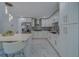 Modern kitchen with white cabinets, marble countertops, and island at 659 Keene Rd, Largo, FL 33771