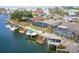 Aerial view of waterfront homes featuring boat docks, seawalls and screened in pools at 6702 Harbor Dr, Hudson, FL 34667