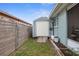 Fenced backyard area featuring a storage shed and manicured landscaping at 6702 Harbor Dr, Hudson, FL 34667