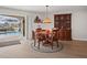 Dining area with wooden furniture, stylish hutch, and a view of the screened-in pool at 6702 Harbor Dr, Hudson, FL 34667