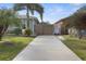 Charming single-story home with a long driveway and mature palm trees at 6702 Harbor Dr, Hudson, FL 34667