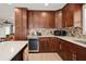 Modern kitchen featuring wood cabinets, stainless steel appliances, and a stone tile backsplash at 6702 Harbor Dr, Hudson, FL 34667