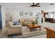 Cozy living room featuring a ceiling fan, comfortable seating, and a view into the open kitchen at 6702 Harbor Dr, Hudson, FL 34667