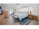 Serene main bedroom featuring wood furnishings, a ceiling fan, and sliding glass doors to the lanai at 6702 Harbor Dr, Hudson, FL 34667