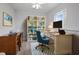 Bright home office space with a large bookshelf, desk, and blue accent chair on a patterned rug at 6702 Harbor Dr, Hudson, FL 34667