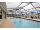 A refreshing swimming pool enclosed by a screen, complete with patio furniture and an outdoor seating area at 6702 Harbor Dr, Hudson, FL 34667