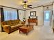 Open living room with view into kitchen and fireplace at 8326 Fantasia Park Way, Riverview, FL 33578