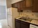 Kitchen features a double sink and wood cabinets at 9011 Westchester Cir # 24, Tampa, FL 33604