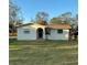 Charming single-story home with stucco siding, arched entryway, and well-maintained lawn at 477 88Th N Ave, St Petersburg, FL 33702