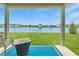 Relaxing covered patio with fire pit overlooks a lake at 10023 Eventide Trl, Parrish, FL 34219