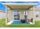 Covered patio with fire pit and seating area at 10023 Eventide Trl, Parrish, FL 34219