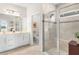 Modern bathroom with double vanity and walk in shower at 10023 Eventide Trl, Parrish, FL 34219