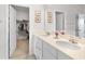 Bathroom with double vanity and access to a walk-in closet at 10023 Eventide Trl, Parrish, FL 34219