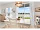 Bright dining area with white table and chairs, overlooking a lake at 10023 Eventide Trl, Parrish, FL 34219