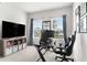 Home office with desk, TV, and comfortable chair at 10023 Eventide Trl, Parrish, FL 34219