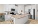 Modern kitchen with stainless steel appliances and granite island at 10023 Eventide Trl, Parrish, FL 34219