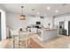 Bright kitchen with white cabinets, granite countertops, and kitchen island at 10023 Eventide Trl, Parrish, FL 34219