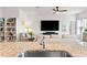 Open concept kitchen and living area with granite counter and large TV at 10023 Eventide Trl, Parrish, FL 34219