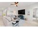 Relaxing living room with sofas, a large TV, and a neutral color scheme at 10023 Eventide Trl, Parrish, FL 34219