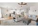 Open living room featuring comfy sofas, a large TV, and tile floors at 10023 Eventide Trl, Parrish, FL 34219
