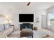 Living room featuring a large TV and comfortable seating at 10023 Eventide Trl, Parrish, FL 34219