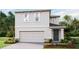 Two-story house with a gray exterior, two-car garage, and landscaping at 10574 Dusty Boot Rd, Land O Lakes, FL 34638