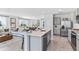 Open-concept kitchen with island and living room views at 10574 Dusty Boot Rd, Land O Lakes, FL 34638