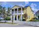 Two-story yellow house with white picket fence and porch at 11139 Winthrop Lake Dr, Riverview, FL 33578