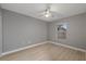 Light gray bedroom with ceiling fan and window at 11162 Libby Rd, Spring Hill, FL 34609