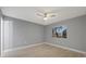 Bright bedroom with ceiling fan and light gray walls at 11162 Libby Rd, Spring Hill, FL 34609