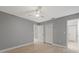 Spacious bedroom with ceiling fan and double-door closet at 11162 Libby Rd, Spring Hill, FL 34609