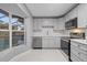 Modern kitchen features stainless steel appliances and white shaker cabinets at 11162 Libby Rd, Spring Hill, FL 34609