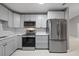 Updated kitchen with stainless steel appliances and gray cabinets at 11162 Libby Rd, Spring Hill, FL 34609