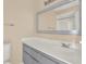 Bathroom boasts a vanity with grey cabinets and a mirror at 11408 Midfield Way # 11408, Tampa, FL 33624