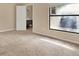 Carpeted bedroom with large window and access to bathroom at 11408 Midfield Way # 11408, Tampa, FL 33624