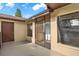 Condo exterior showcasing a screened-in entryway and adjacent door at 11408 Midfield Way # 11408, Tampa, FL 33624