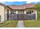 Exterior view of a condo with a wooden fence and walkway at 11408 Midfield Way # 11408, Tampa, FL 33624