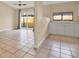 Open kitchen with white cabinets, stainless steel appliances, and tile floors at 11408 Midfield Way # 11408, Tampa, FL 33624