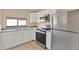 Galley-style kitchen featuring stainless steel appliances and granite countertops at 11408 Midfield Way # 11408, Tampa, FL 33624