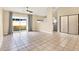 Spacious living room with tile floors and access to a patio at 11408 Midfield Way # 11408, Tampa, FL 33624