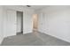 Bright bedroom with grey carpet and double door closet at 1149 Kistna Dr, Zephyrhills, FL 33540