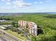 Panoramic aerial showcasing the condo community alongside a highway, city and sprawling natural beauty at 12033 Gandy N Blvd # 145, St Petersburg, FL 33702