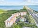 Breathtaking aerial view showcasing condos, a pool, lush greenery, and stunning ocean vistas at 12033 Gandy N Blvd # 145, St Petersburg, FL 33702