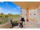 Inviting condo balcony features comfortable outdoor seating and serene, green views at 12033 Gandy N Blvd # 145, St Petersburg, FL 33702