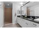 Bathroom featuring double sinks, granite countertop, walk-in shower with glass door, and hardwood floors at 12033 Gandy N Blvd # 145, St Petersburg, FL 33702