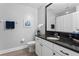 Bathroom with a sink, toilet, hardwood floors and framed mirror at 12033 Gandy N Blvd # 145, St Petersburg, FL 33702