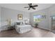 This bedroom features hardwood floors, a ceiling fan, a window, and two bedside tables with lamps at 12033 Gandy N Blvd # 145, St Petersburg, FL 33702