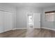 Bedroom with hardwood floors, bi-fold closet, window and view of hall at 12033 Gandy N Blvd # 145, St Petersburg, FL 33702