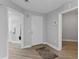 Hallway with hardwood floors, white trim and multiple doorways at 12033 Gandy N Blvd # 145, St Petersburg, FL 33702